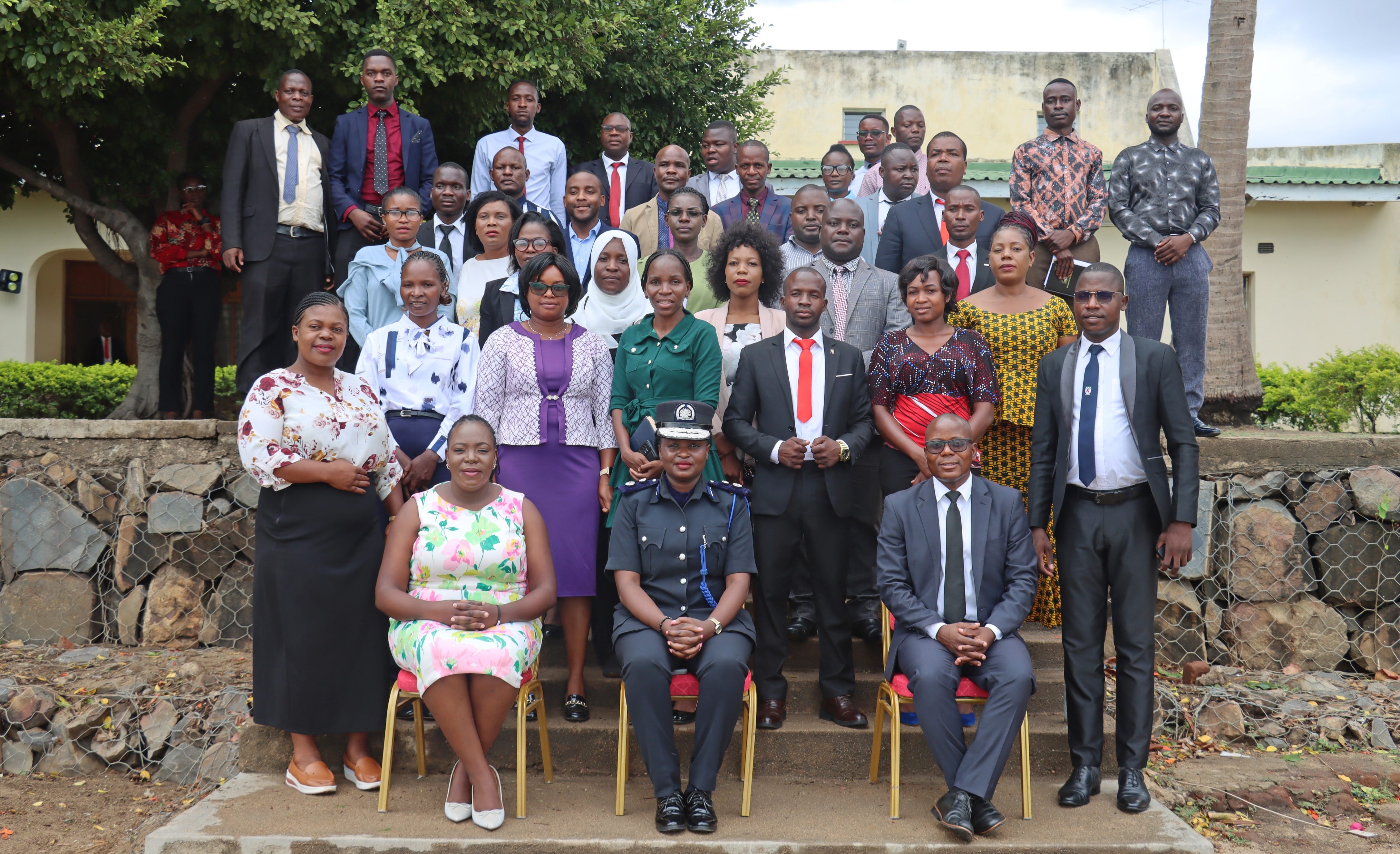 Participants pose for a group photograph with the Guest of honour