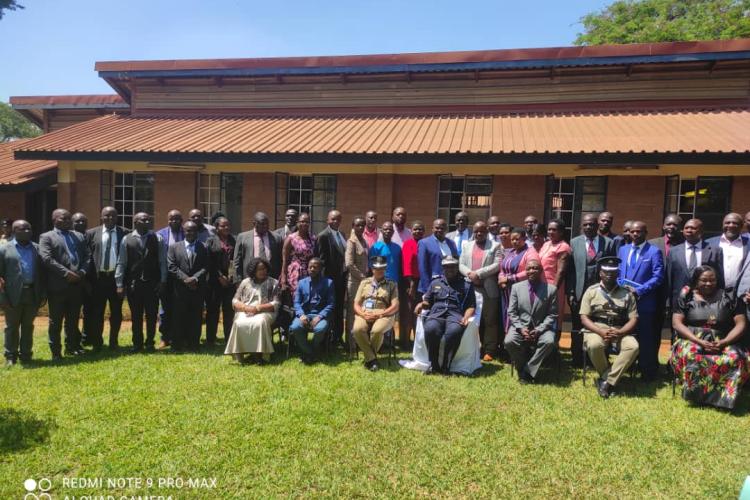 The IGP pose for a group photograph with participants